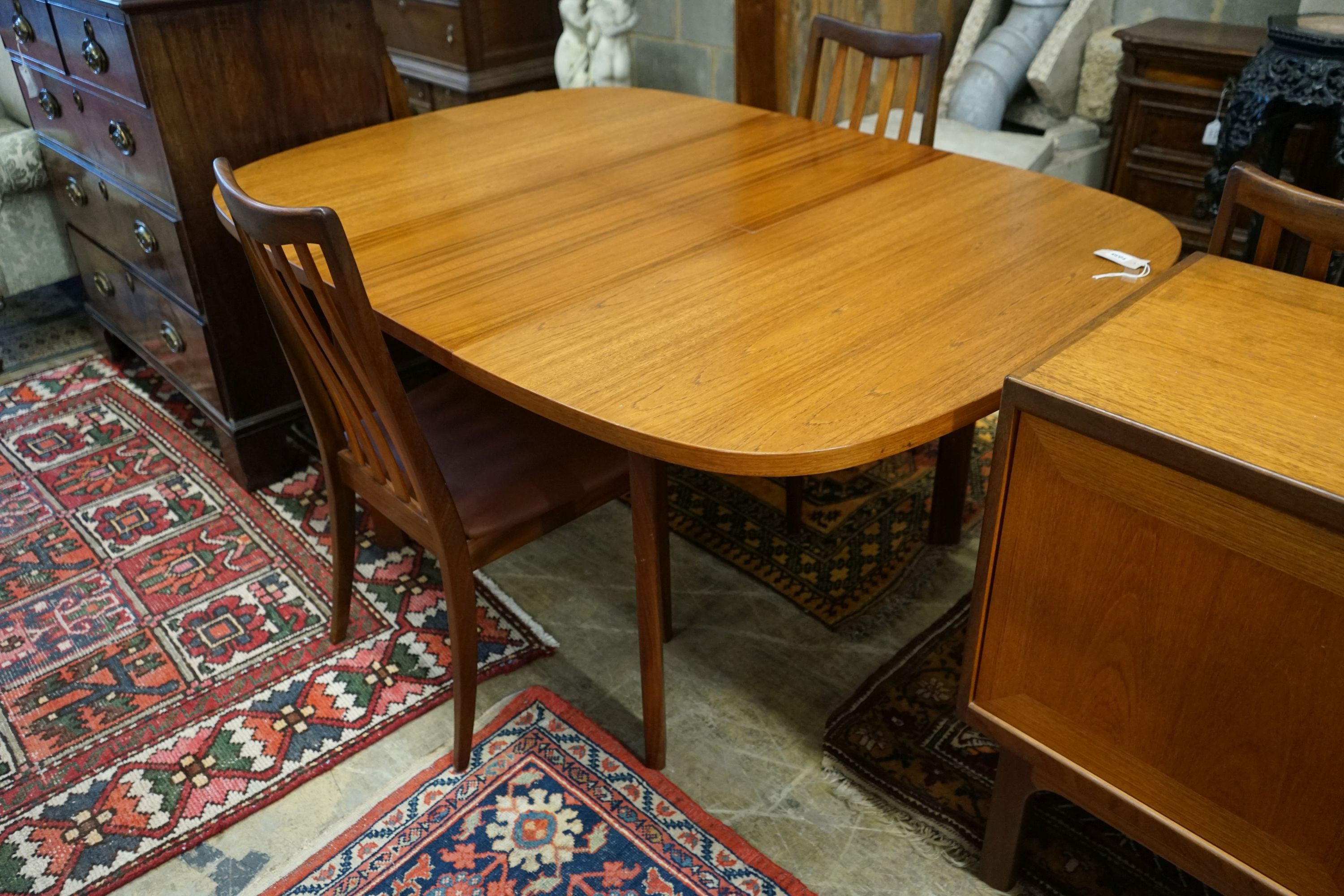 A G Plan teak dining suite comprising extending table, 158cm extended, width 112cm, height 72cm, four chairs and a sideboard
